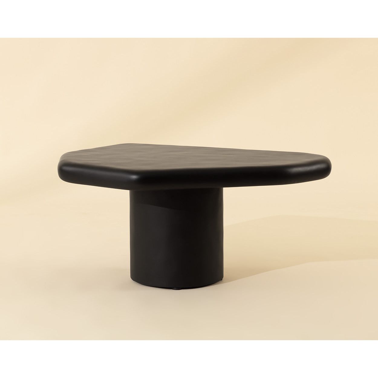 Table basse d'extérieur contemporaine en béton noir, avec une forme géométrique compacte, idéale pour un balcon.