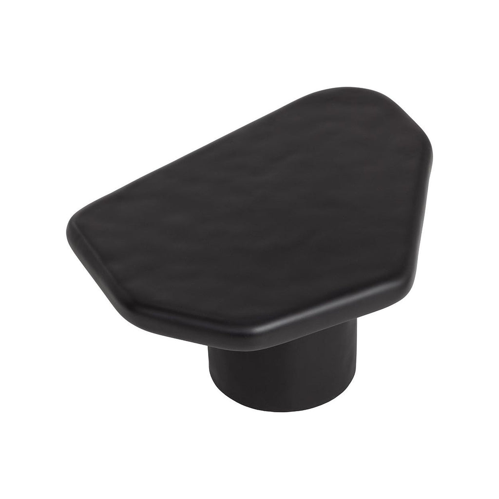 Table basse d'extérieur contemporaine en béton noir, avec une forme géométrique compacte, idéale pour un balcon.